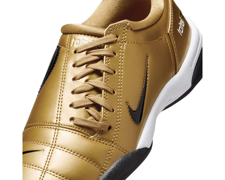 Football boots made of synthetic leather in metallic gold.